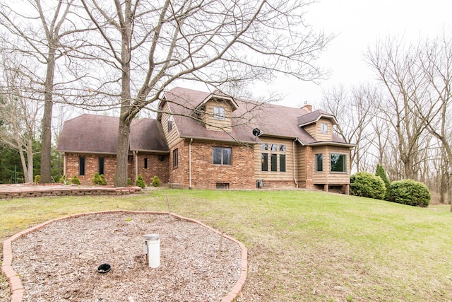 exterior space with brick siding, roof with shingles, and a lawn