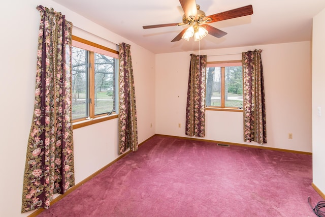 unfurnished room with baseboards, a ceiling fan, carpet, and a healthy amount of sunlight