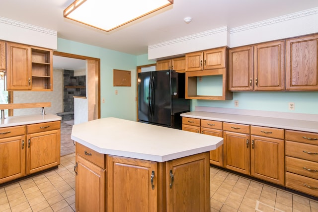 kitchen with freestanding refrigerator, light countertops, open shelves, and light tile patterned floors