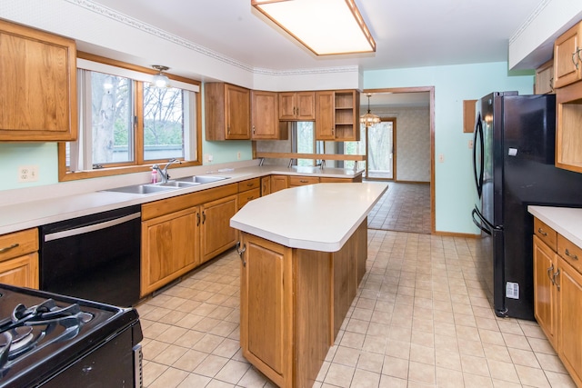 kitchen featuring a sink, light countertops, black appliances, and a kitchen island