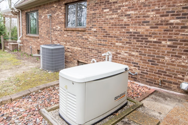 details with central AC, brick siding, and a power unit