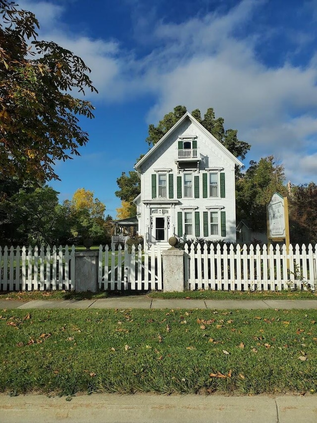 greek revival house featuring a fenced front yard