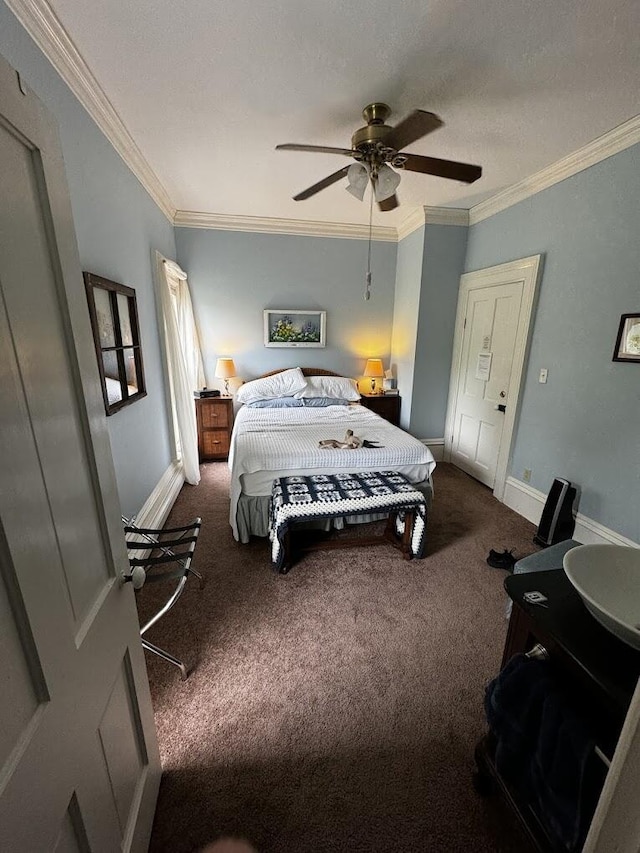 carpeted bedroom featuring baseboards, ornamental molding, and a ceiling fan