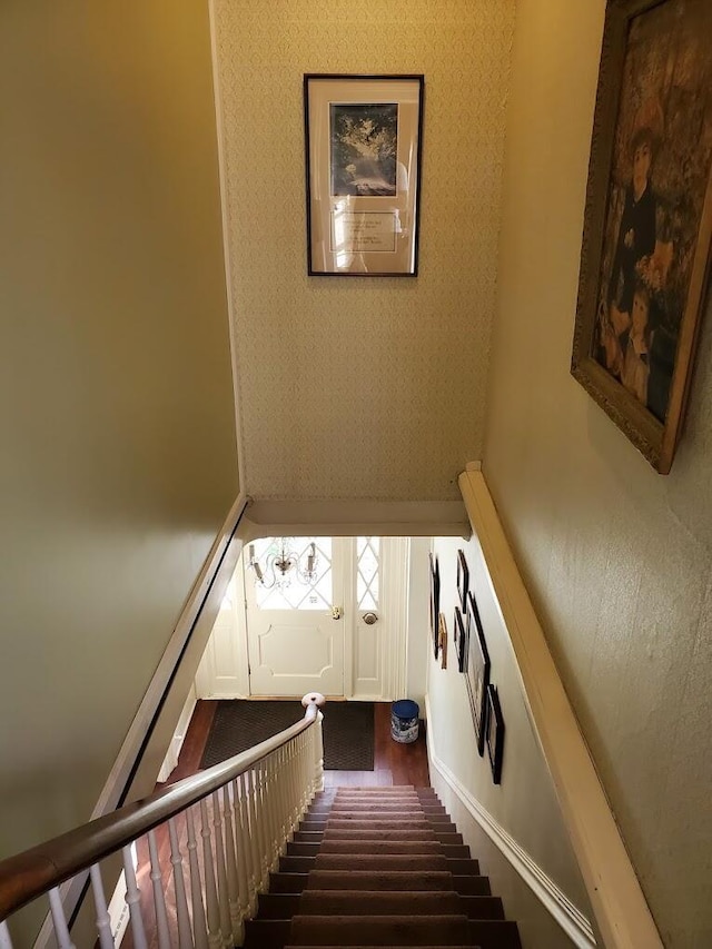 stairs featuring wood finished floors