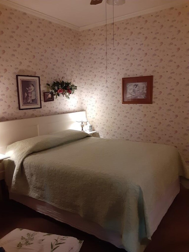 bedroom with ornamental molding, a ceiling fan, and wallpapered walls