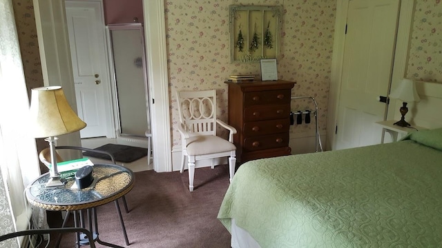 bedroom with wallpapered walls and carpet