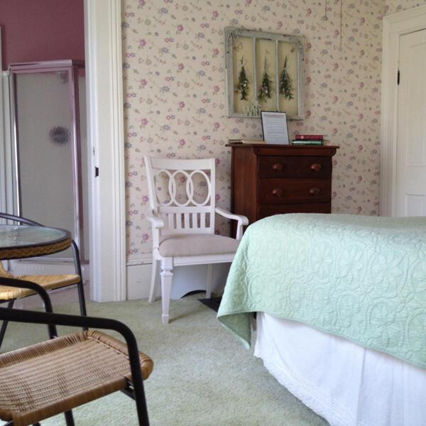 carpeted bedroom with wallpapered walls