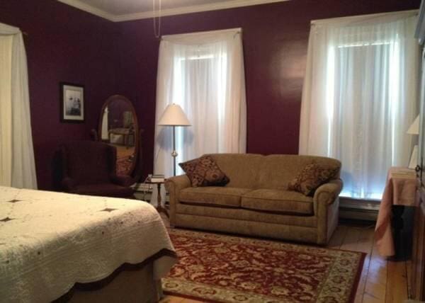 bedroom with crown molding and wood finished floors