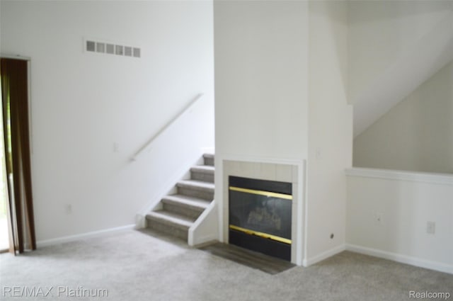 12201 Pinehurst Ln, Grand Blanc, MI 48439 - unfurnished living room with carpet flooring, a fireplace, baseboards, and stairs
