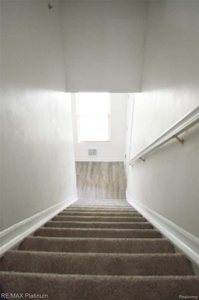 12201 Pinehurst Ln, Grand Blanc, MI 48439 - stairs featuring baseboards and carpet floors