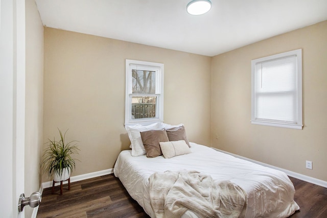 bedroom with baseboards and dark wood-style floors