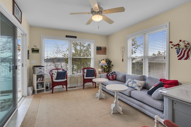 living room featuring ceiling fan and visible vents