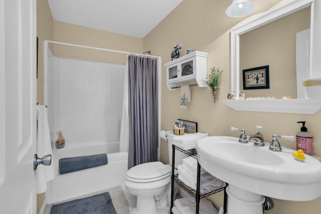 full bathroom with a sink, toilet, and shower / bath combo with shower curtain