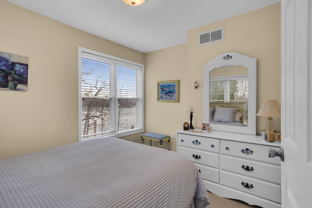 bedroom featuring visible vents and multiple windows