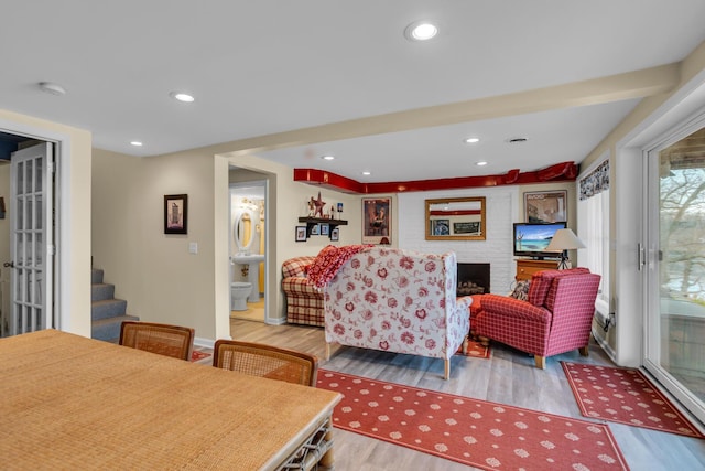 living room featuring recessed lighting, stairway, wood finished floors, and baseboards