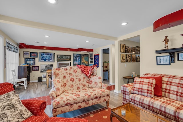 living area with baseboards, recessed lighting, and wood finished floors