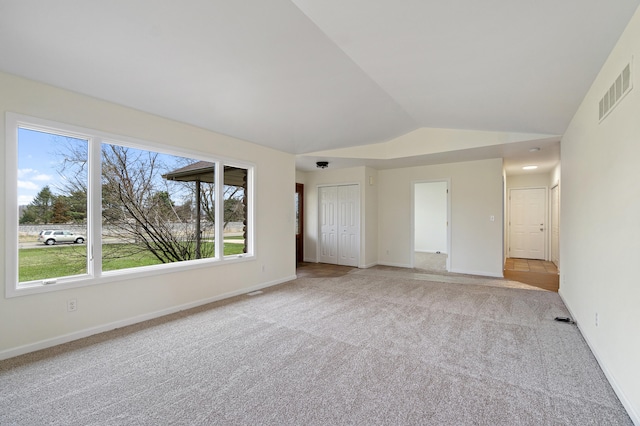 interior space with visible vents, baseboards, and vaulted ceiling