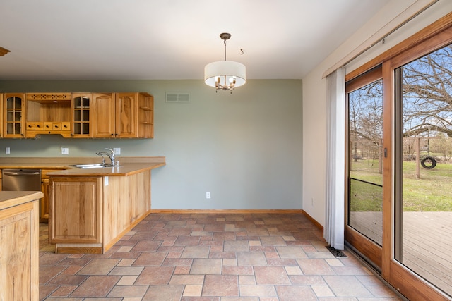 kitchen featuring baseboards, open shelves, visible vents, stone finish flooring, and dishwasher