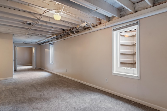 basement featuring baseboards and carpet