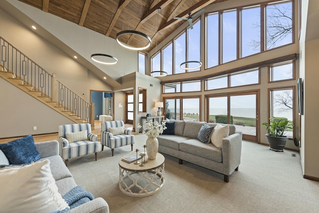 living room featuring high vaulted ceiling, carpet, wood ceiling, and beam ceiling