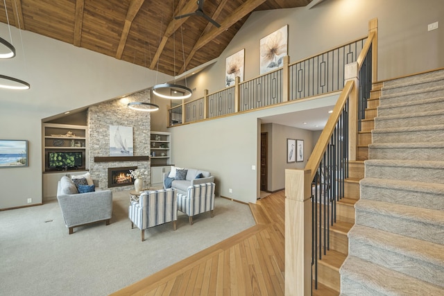 living room with baseboards, high vaulted ceiling, hardwood / wood-style floors, and wood ceiling
