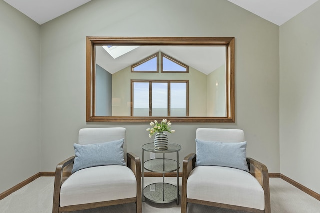 sitting room featuring carpet floors, baseboards, and vaulted ceiling