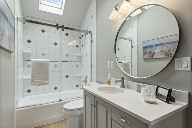 bathroom with shower / bath combination with glass door, vanity, toilet, wood finished floors, and lofted ceiling with skylight