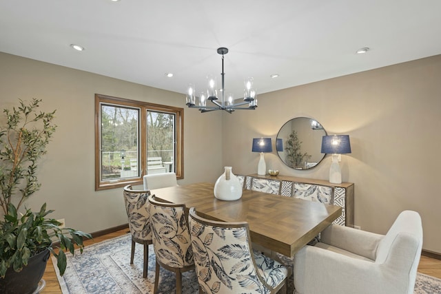 dining room with recessed lighting, light wood-style floors, baseboards, and an inviting chandelier