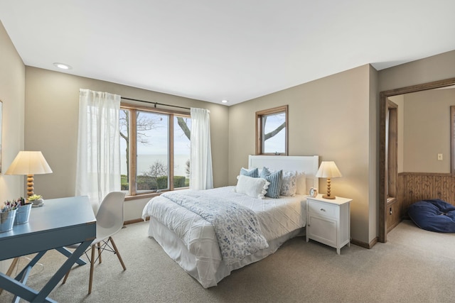 bedroom featuring light carpet and baseboards