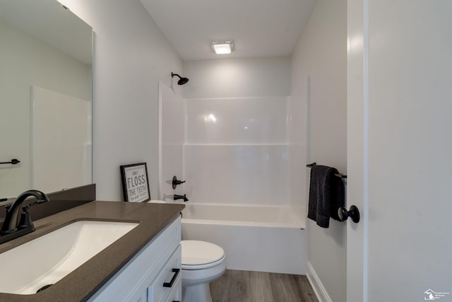 bathroom featuring  shower combination, vanity, toilet, and wood finished floors