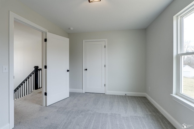 interior space featuring carpet and baseboards