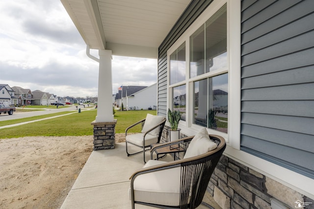 view of patio / terrace featuring a porch and a residential view