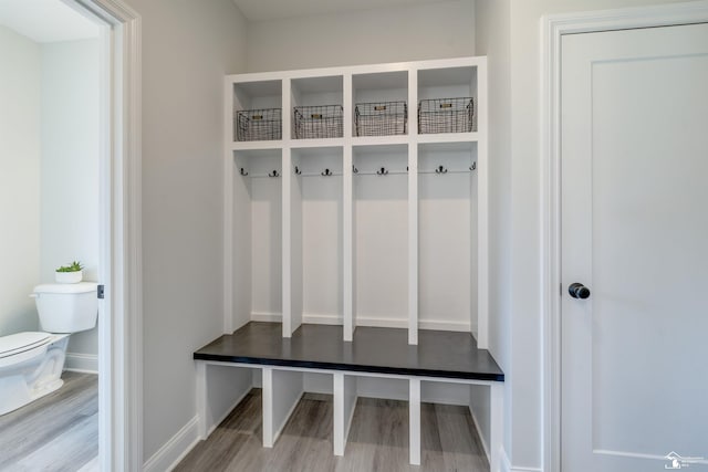 mudroom with baseboards and wood finished floors