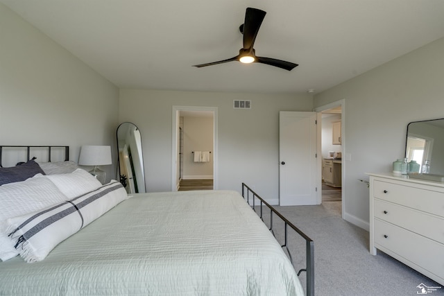 bedroom with baseboards, light carpet, a ceiling fan, connected bathroom, and visible vents