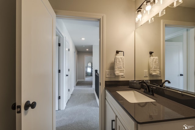 bathroom featuring recessed lighting, vanity, and baseboards