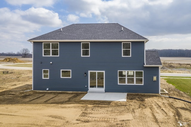 rear view of property with a patio area and a shingled roof