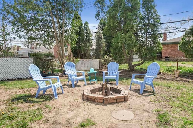 view of yard with an outdoor fire pit and fence