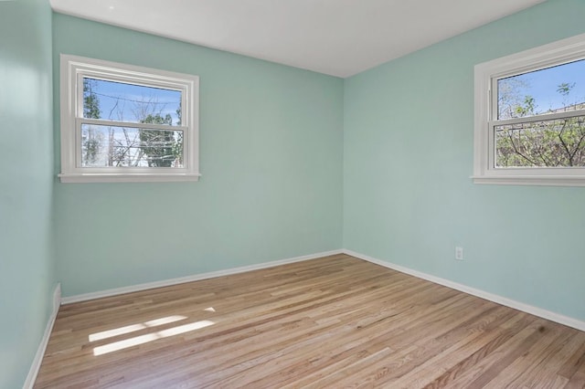 unfurnished room with wood finished floors and baseboards