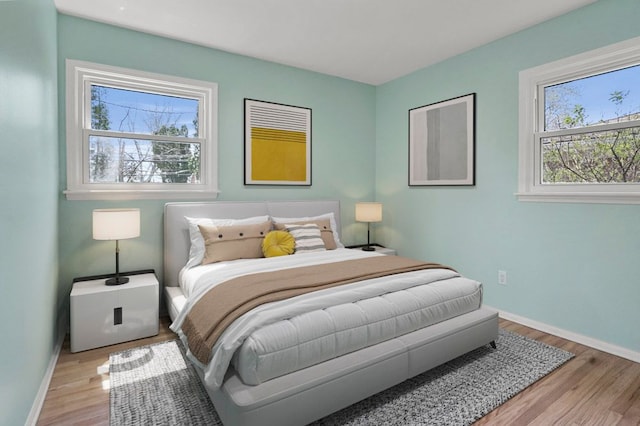 bedroom with wood finished floors and baseboards