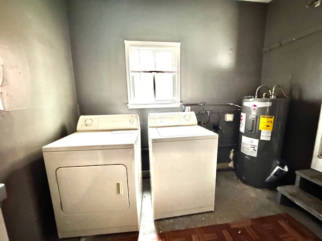 laundry area with washing machine and clothes dryer, dark colored carpet, laundry area, and electric water heater