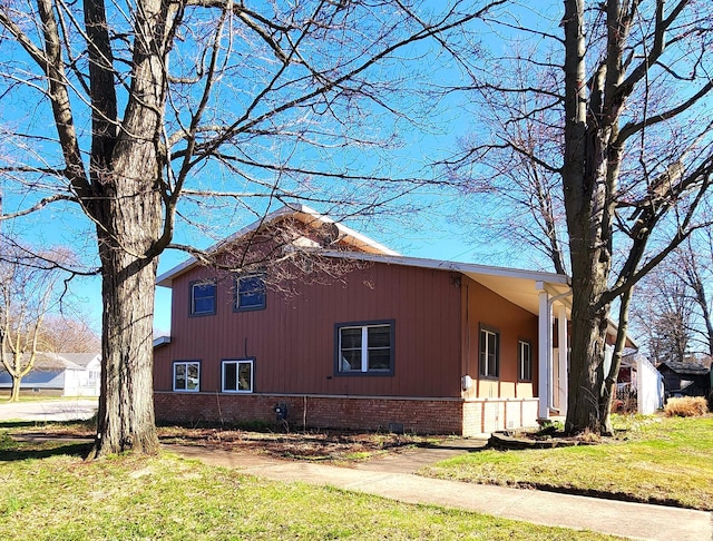view of home's exterior featuring a yard and brick siding