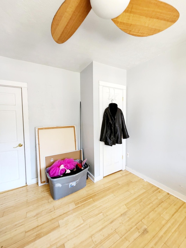 bedroom with baseboards and wood finished floors