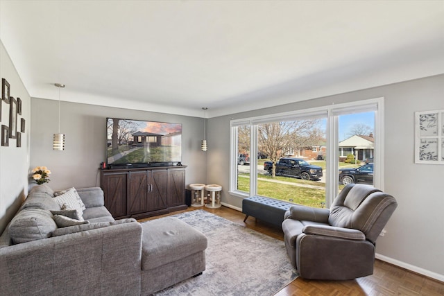 living area featuring baseboards