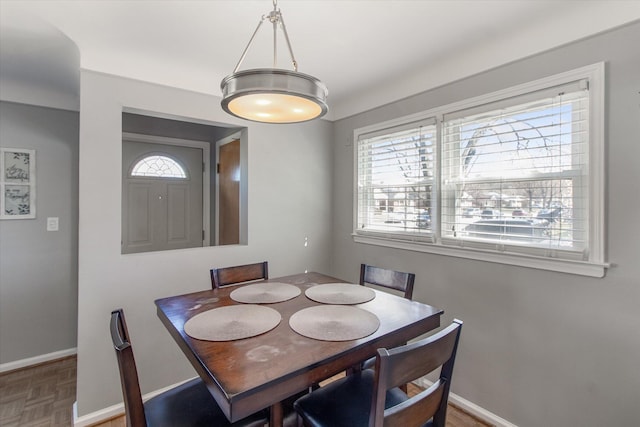 dining area featuring baseboards