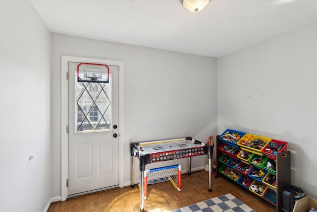 recreation room with baseboards