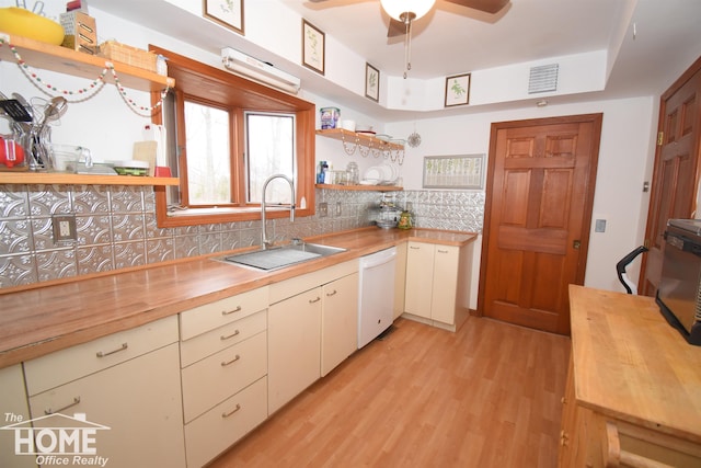 kitchen featuring a sink, open shelves, dishwasher, and butcher block counters