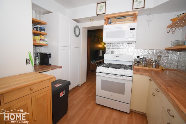 kitchen with tasteful backsplash, open shelves, white appliances, light wood-style floors, and butcher block counters