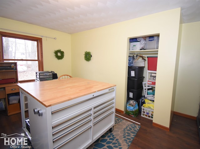 office space featuring baseboards and wood finished floors