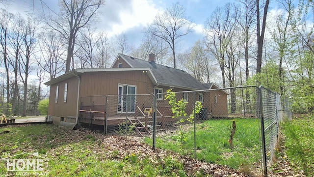 4405 E M-71 Rd, Corunna, MI 48817 - view of home's exterior featuring a deck, fence, and a chimney