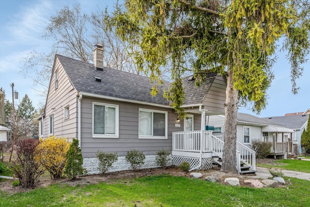 23737 Couzens Ave, Hazel Park, MI 48030 - view of front of house featuring a front lawn, a shingled roof, and a chimney